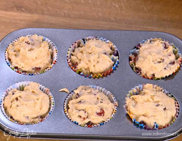 В формочки для кексов вставить бумажные вкладыши и разложить в них тесто.