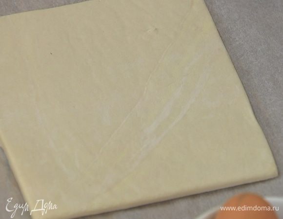 На рабочую поверхность высыпать 1 ст. ложку сахара и раскатать на нем тесто в тонкий пласт, затем перевернуть, присыпать оставшимся сахаром и еще немного раскатать.
