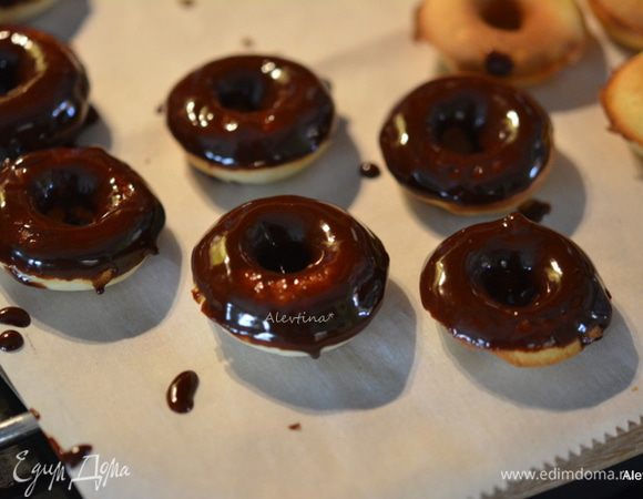 Окунать каждый пончик в шоколад. Выкладывать на противень.