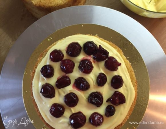 На корж выкладываем крем и вишню (можно замороженную, можно свежую).