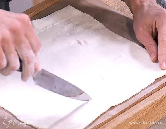 Отступая на полтора сантиметра от краев и не прорезая тесто насквозь, ножом прочертить прямоугольник меньшей площади, так чтобы получились бортики.