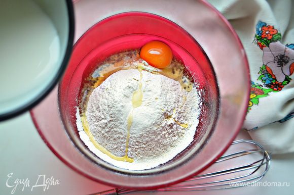 Вбить 1 яйцо, всыпать 140 г просеянной муки, 0,5 ч. л. сахара и постепенно добавить 300 мл молока.