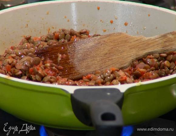 Добавить готовую чечевицу, молотый пеперончино, посолить, поперчить и перемешать.