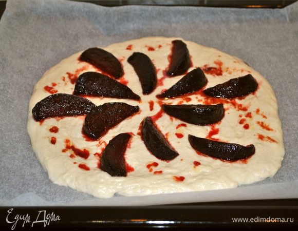 Тесто делим на 2 равные части. Из каждой делаем лепешку 25 см в диаметре. На первую лепешку выкладываем половину свеклы, немного поливаем соком, оставшимся после обжаривания.