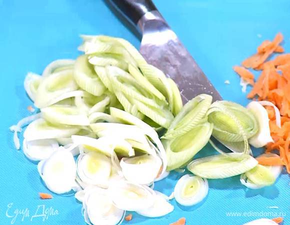Светлую часть лука-порея нарезать тонкими кольцами.