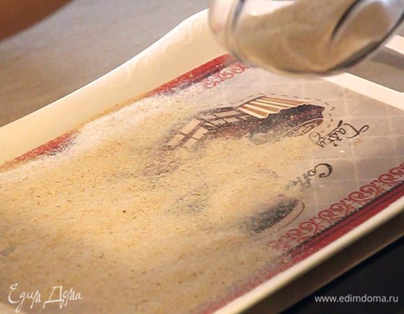 Тем временем подготавливаем разнос и посыпаем его панировочными сухарями. Так будет быстрее и удобнее обваливать в панировке маленькие котлетки.