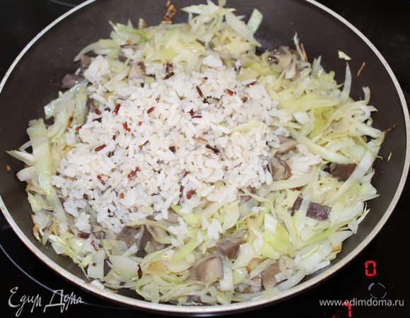 Добавить отваренный рис, посолить, поперчить по вкусу, перемешать.