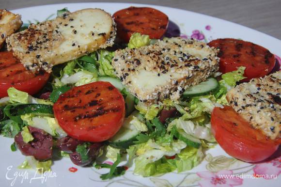 Салат выложить на блюдо, сверху поместить помидоры срезом вверх и обжаренный сулугуни.