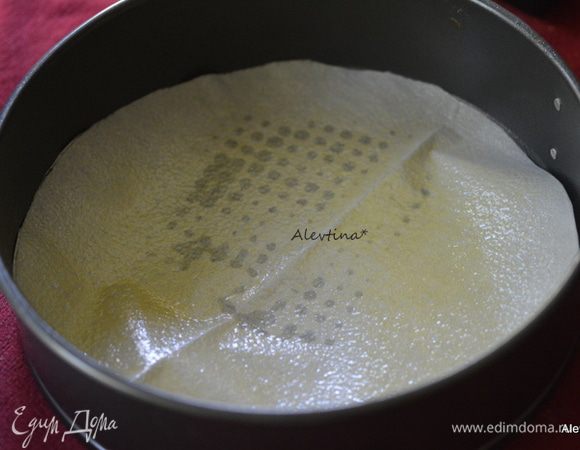 Круглую форму съемную 23 см смазать маслом, выстелить на дно бумагу для выпечки. Смазать вновь маслом.
Разогреть духовку до 180°С.