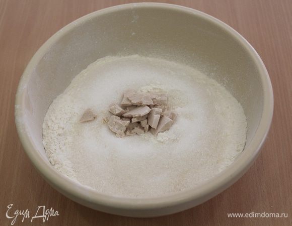 Изюм предварительно замочить в коньке. Просеять муку (пару горсточек муки отложите, возможно вам понадобится чуть меньше, и лучше добавить позже), добавить сахар, соль, в середке сделать углубление и положить туда дрожжи.