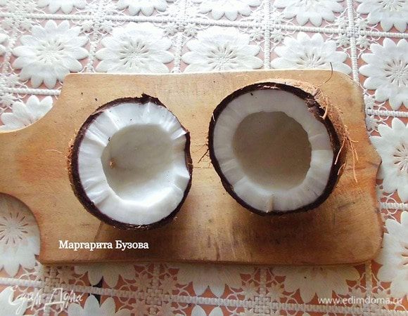 Прежде всего нужно открыть кокос (я бы посоветовала доверить это дело мужчине!). Для этого нужно проделать отверстие в одном из трех "глазков" и слить оттуда воду, если она там окажется. Я советую покупать кокос с водой, тогда он будет более сочный. Чтобы выбрать именно такой кокос, нужно его взять в руки, немного потрясти, и Вы услышите воду. К тому же сочный кокос более тяжелый по сравнению с теми, внутри которых нет воды. 
После того, как вода будет слита, нужно расколоть орех пополам. Возьмите большой нож или молоток и постучите им по кокосу. Нужно бить по центру, все время проворачивая кокос. Дальше он либо расколется на 2 части, либо скорлупа сама отделится от мякоти. У меня он раскололся на 2 части.