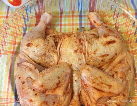 Духовку нагреть до 200°С. Цыпленка натереть, морской солью и аджикой, переложить в форму для запекания и отправить в духовку.