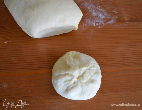 Выложить его на рабочую поверхность, слегка припыленную мукой, обмять и поделить на 12 равных частей. Кусочки теста получаются по 108 г. Каждый кусочек теста слегка размять ладонью, а затем собрать "узелком", завернув к центру со всех сторон.