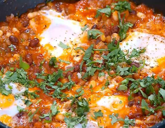 Кинзу мелко порубить и посыпать готовые яйца с фасолью. Подавать со сметаной.