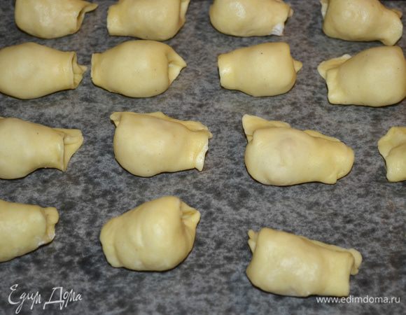 Выложить подушечки на противень, застеленный пекарской бумагой. Выпекать при 180°C примерно 30 минут, до румяного цвета.