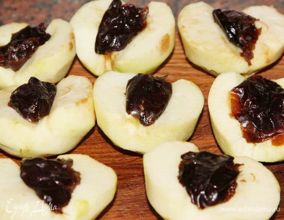 Готовим начинку: яблоки чистим от кожуры, разрезаем пополам и избавляемся от сердцевины. В каждую выемку помещаем половинку финика и половинку сливы.