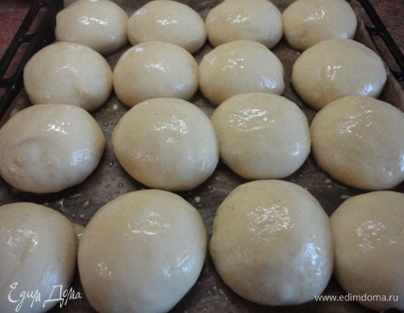 Выкладываем на противень, выстланный бумагой. Даем расстояться. Время расстойки зависит от температуры воздуха в помещении. Смазываем оставшимся желтком, смешанным с молоком.