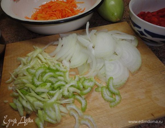 За это время подготовим все овощи. Кабачок нарезать такими же кубиками. Луковицу нарезать тонкими полукольцами. Морковь натереть на крупной терке или нашинковать соломкой. Чеснок порубить, перец и сельдерей нарезать небольшими кусочками.
