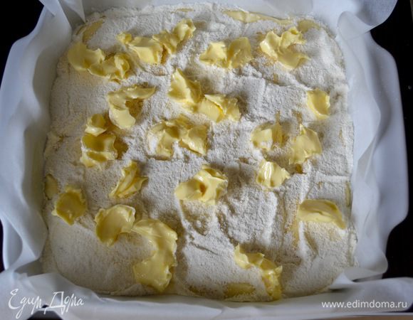 Равномерно засыпать творожный слой оставшейся мучной смесью. И разложить произвольно кусочки сливочного масла — 60 г!