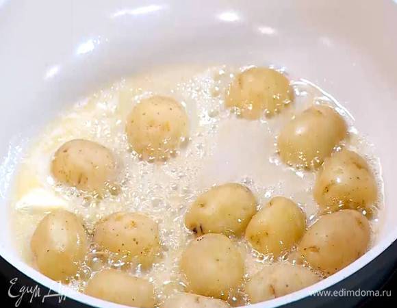 Разогреть в сковороде оливковое и сливочное масло, выложить картофель срезами вниз и обжаривать до появления золотистой корочки.