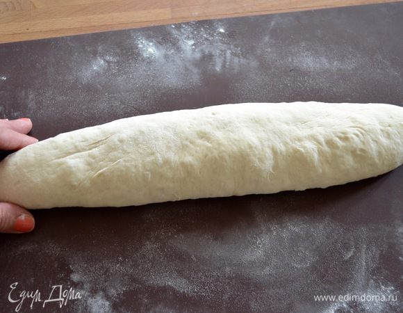 Теперь переверните тесто швом вниз и обеими руками покатайте его по столу (я все эти манипуляции с хлебом проделываю на силиконовом коврике, т.к. в последствии с помощью него легче переносить и перекладывать хлеб). Катайте хлеб по коврику, придавая ему закругленную форму и постепенно "сползая" обеими ладонями к концам буханки, немного сужая ее... Сформированную таким образом буханку снова накройте полотенцем и сверху пакетом. Оставьте еще на 20 минут.