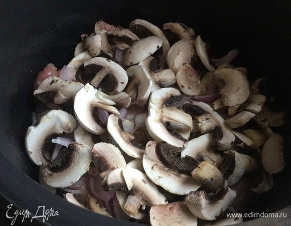 Сверху выложите тонко нарезанные шампиньоны.