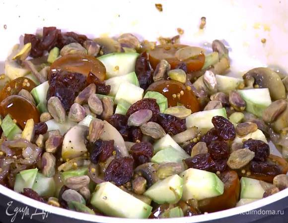 Нарезанные помидоры, цукини, клюкву и фисташки добавить в сковороду, все перемешать и обжарить еще немного.