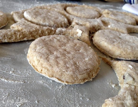 Рабочую поверхность посыпать мукой, положить на нее тесто и снова припудрить мукой. Тесто раскатать в пласт толщиной в 1,5-2 см и вырезать формой сконы. 