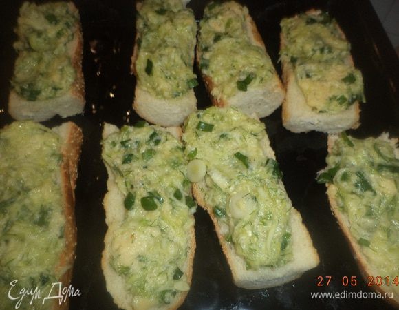 Противень смазать маслом, выложить кусочки багета. На каждый кусок выложить несколько ложек начинки.
