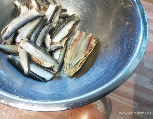 Рыбку необходимо очистить от головы и хребта. При большом количестве это работа займет время, но при определенной сноровке не потребует особого труда. Берете рыбку за голову, отрываете ее, за головой потянутся и внутренности. Затем нажать на кильку, она раскроется и вынуть хребет. Очищенную кильку промыть под проточной водой. 