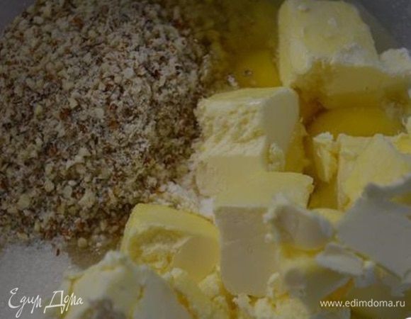 В миске смешать муку, сахар, соль, ванилин и молотые орехи. Добавить порубленное масло и 2 яйца.