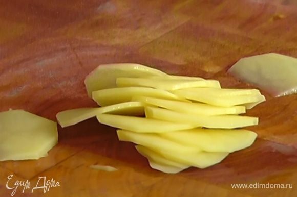 Картофель вымыть, нарезать кусочками 2‒3 мм толщиной, выложить в миску, полить 3 ст. ложками оливкового масла, посыпать тимьяном, посолить и поперчить.
