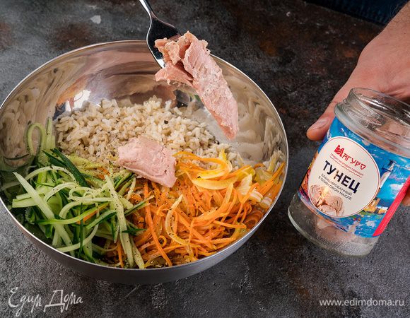 С тунца сливаем лишнюю жидкость, добавляем к остывшему рису. Все перемешать, посыпать свежемолотым черным перцем. 