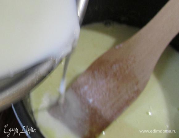 Горячую молочную смесь влить тонкой струйкой, не прекращая помешивать, в желтковую массу.