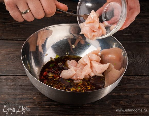 Опустить курицу в маринад так, чтобы все кусочки были покрыты, присыпать кинзой и оставить на полчаса.