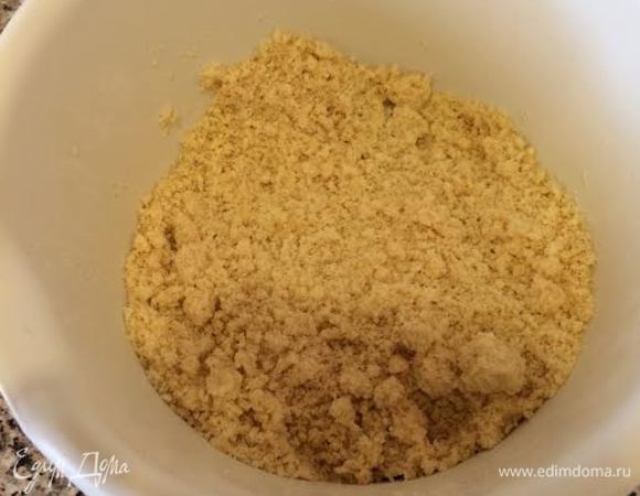 Духовку нагреть до 180°С. Форму 20х20 застелить бумагой для выпечки. В миске смешать муку, соль, разрыхлитель, соду и растопленное сливочное масло. Должна получиться крошка.