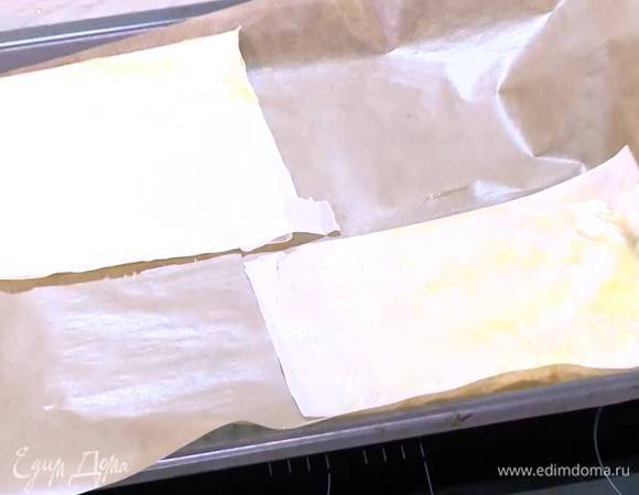 Каждый лист теста фило смазать оливковым маслом, сложить пополам, еще раз смазать маслом, опять сложить пополам и поместить на выстеленный пищевой бумагой противень.