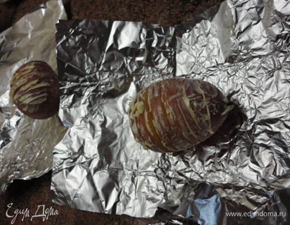 Картофель не чистить, а тщательно вымыть щеткой и обсушить. Надрезать каждую на тонкие ломтики, чтобы можно было раскрыть, как веер, и смазать мягким сливочным масло, стараясь попасть и между пластинками картофеля. По желанию можно посолить и поперчить, но я этого не делаю. 