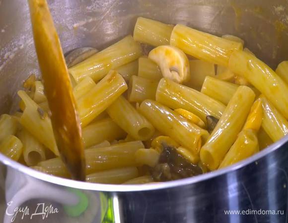 В кастрюлю с макаронами добавить грибной соус, влить немного воды, в которой замачивались грибы, и несколько столовых ложек воды, в которой варились макароны, все перемешать и слегка прогреть.