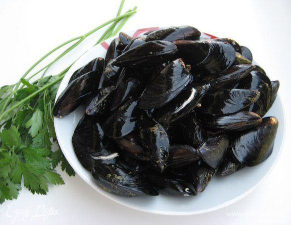 Мидии промыть под проточной водой с щеткой, удалить водоросли, за которые мидии держались в море за камни. Положить мидии в сотейник, влить вино, закрыть крышкой, готовить 10 минут на сильном огне, переодически потряхивая сковороду. Добавить мелко порубленную петрушку.