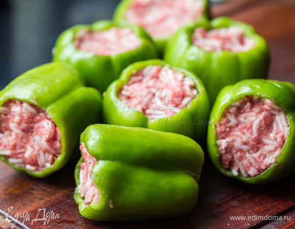 Добавить остывший рис и перемешать руками. Нафаршировать перцы, слегка утрамбовывая. Фарш немного увеличится в процессе готовки, поэтому не стоит класть слишком много.