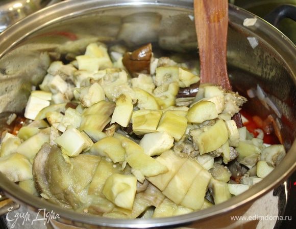 С баклажанов снять кожицу, нарезать их кусочками, добавить в луковую смесь. Добавить все специи, уксус, измельченный чеснок. Тушить 15-20 минут.