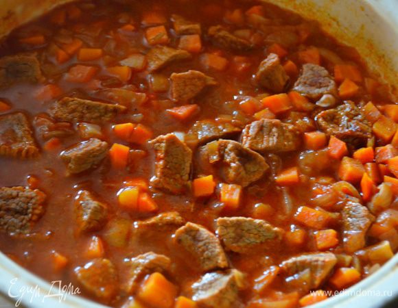 Мясо посолить, поперчить, добавить нарезанные лук и морковь, перемешать и тушить все вместе еще минут 20.