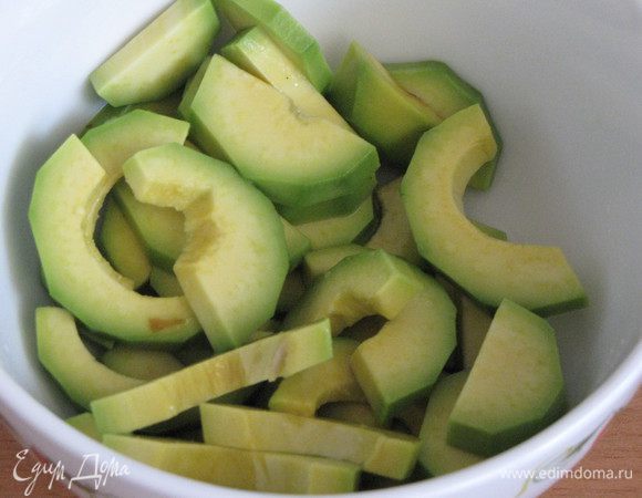 Но мы приготовим еще и салат! Для этого почистим авокадо, нарежем ломтиками и сбрызнем лимонным соком, чтобы не потемнел.