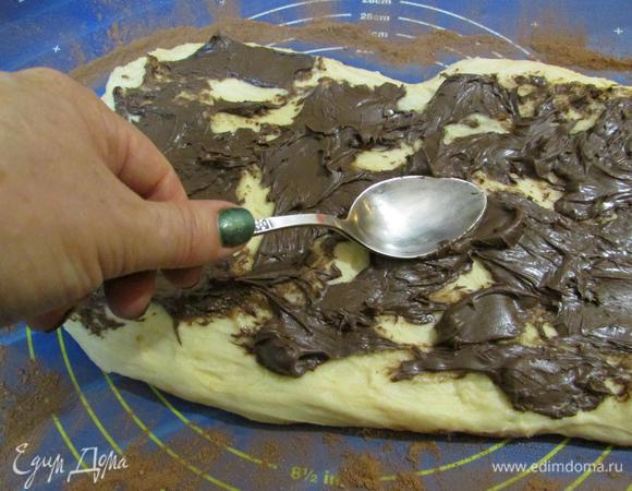 Руками придать тесту форму прямоугольника (длина равна длине вашей формы, у меня 32 см). С помощью ложки размазать шоколадную пасту по всей площади теста.