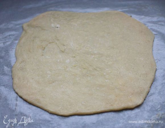 Вновь подошедшее тесто еще раз обминаем, скатываем в колбаску и делим на 8 частей. Каждую часть защипляем от краев к центру, слегка придавливаем кулаком, переворачиваем получившимся швом вниз и убираем под полотенце. 