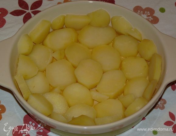 Форму для запекания смазать растительным маслом. Картофель крупно нарезать и уложить на дно формы.