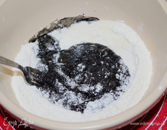 В середину мучной смеси добавить яичную смесь и аккуратно вилочкой начинать постепенно вмешивать муку.