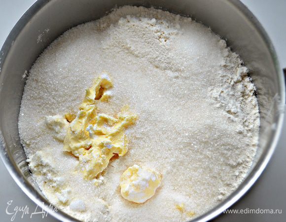 Порубите ножом сливочное масло. Просеянную муку смешайте с разрыхлителем. Приготовьте тесто, добавив к маслу сахар, ванильный сахар, щепотку соли, творог и муку.