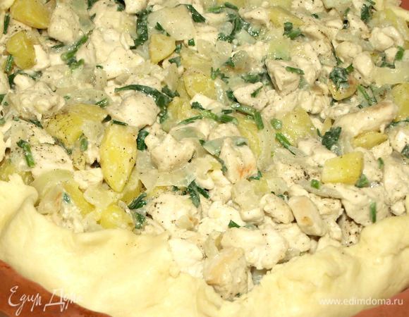 Тесто делим на несколько частей. Первую часть раскатываем, перекладываем в форму, обрезаем лишнее. Выкладываем на тесто начинку и поднимаем края теста вверх. 